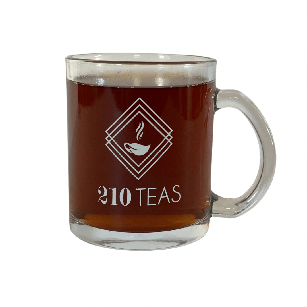 Clear Glass Tea Mug filled with dark liquid for 210 Teas' logo visibility